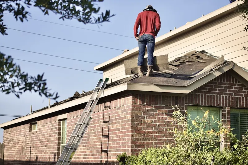 Professional roofer working on a residential roof in Haw Creek